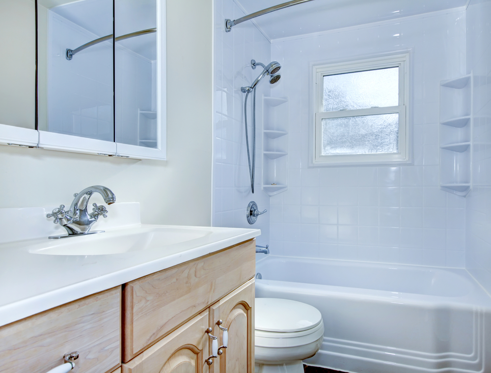 Bathroom interior with light tone vanity cabinet and tile floor. Northwest, USA