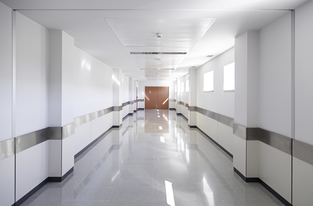 Deep hospital corridor, detail of a white corridor in a hospital, architecture and health